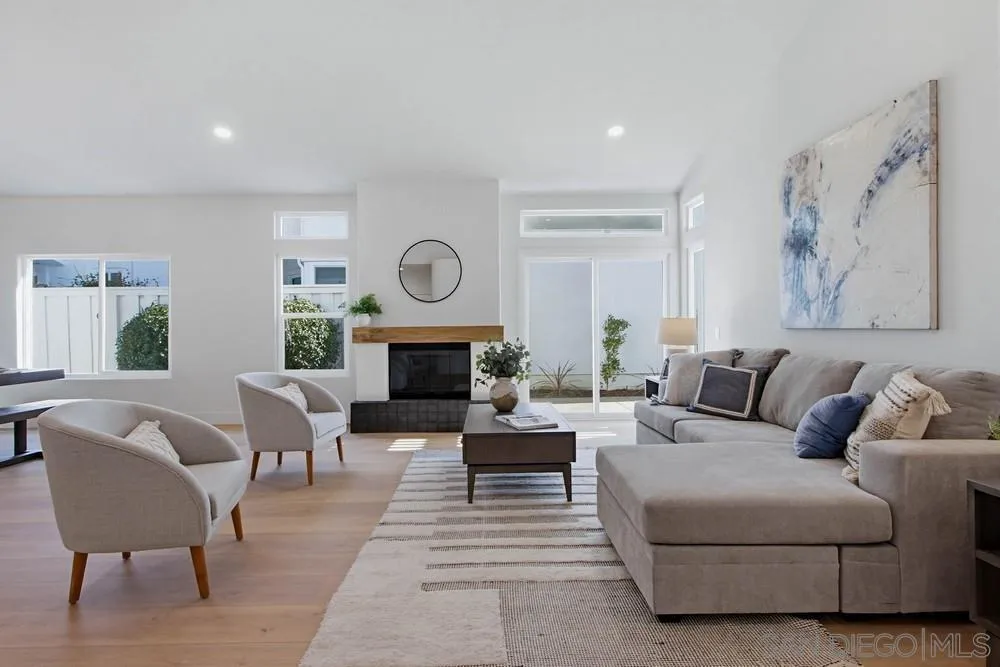 4959 Lamia Way Oceanside, CA 92056 - Photo 13 of 63 a living room with furniture a clock and a fireplace