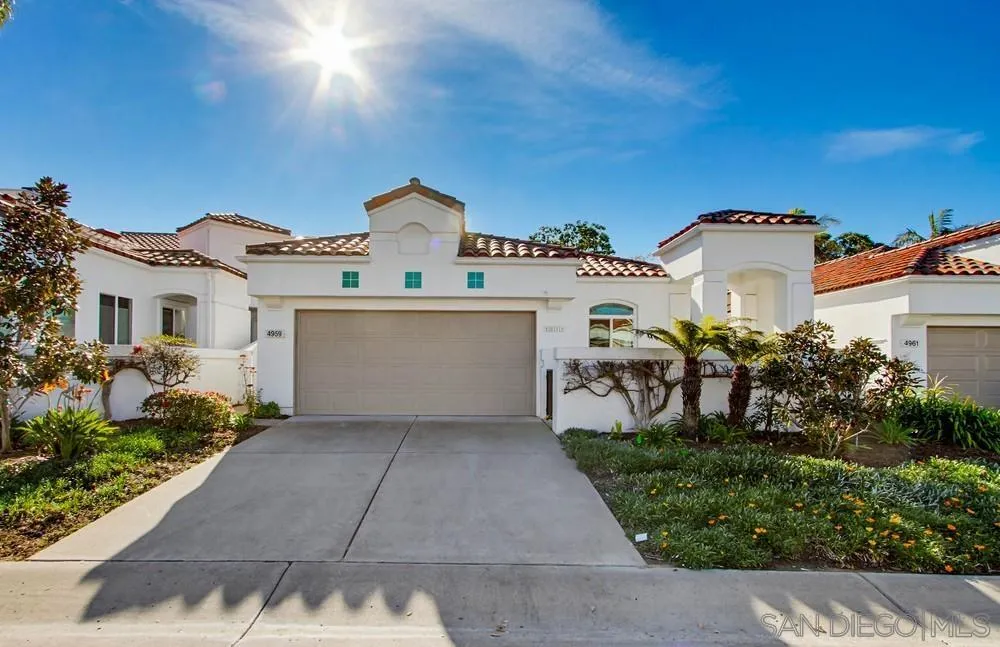 4959 Lamia Way Oceanside, CA 92056 - Photo 2 of 63 a view of a white house with potted plants in front of it