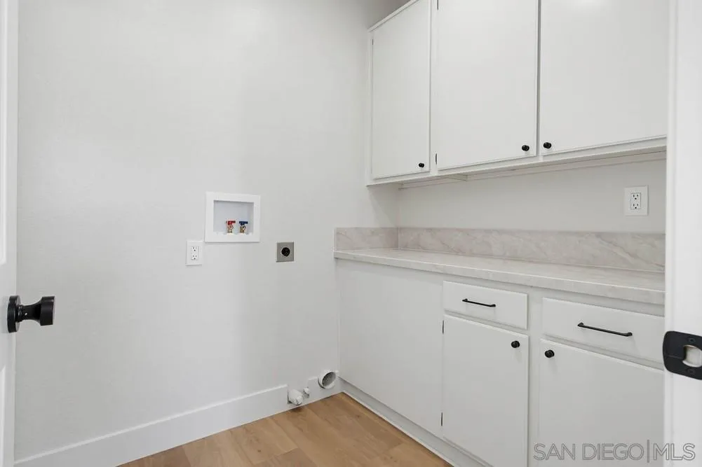 4959 Lamia Way Oceanside, CA 92056 - Photo 25 of 63 a view of a kitchen with white cabinets