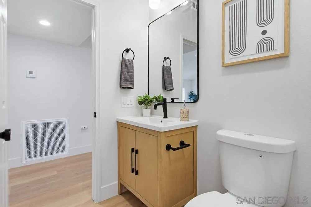 4959 Lamia Way Oceanside, CA 92056 - Photo 34 of 63 a bathroom with a sink mirror vanity and toilet