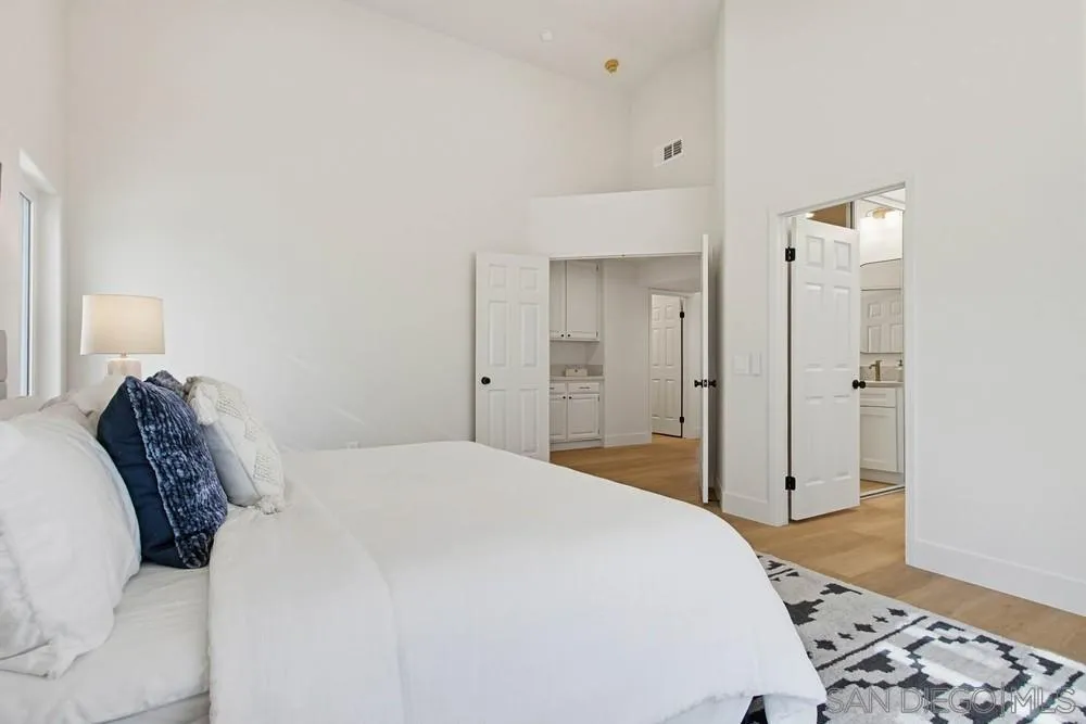 4959 Lamia Way Oceanside, CA 92056 - Photo 39 of 63 a bedroom with a bed and a mirror