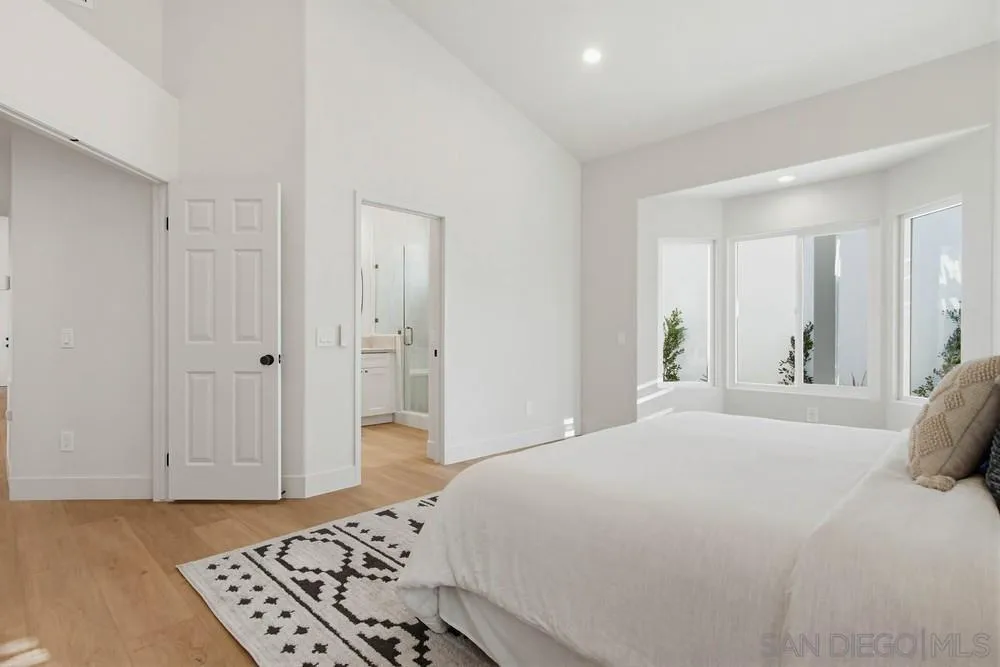 4959 Lamia Way Oceanside, CA 92056 - Photo 40 of 63 a bedroom with a bed and a chandelier