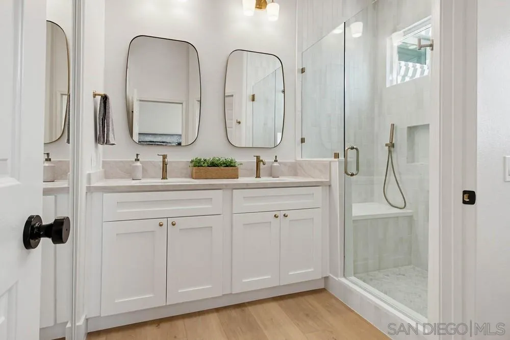 4959 Lamia Way Oceanside, CA 92056 - Photo 41 of 63 a bathroom with a double vanity sink mirror and bathtub