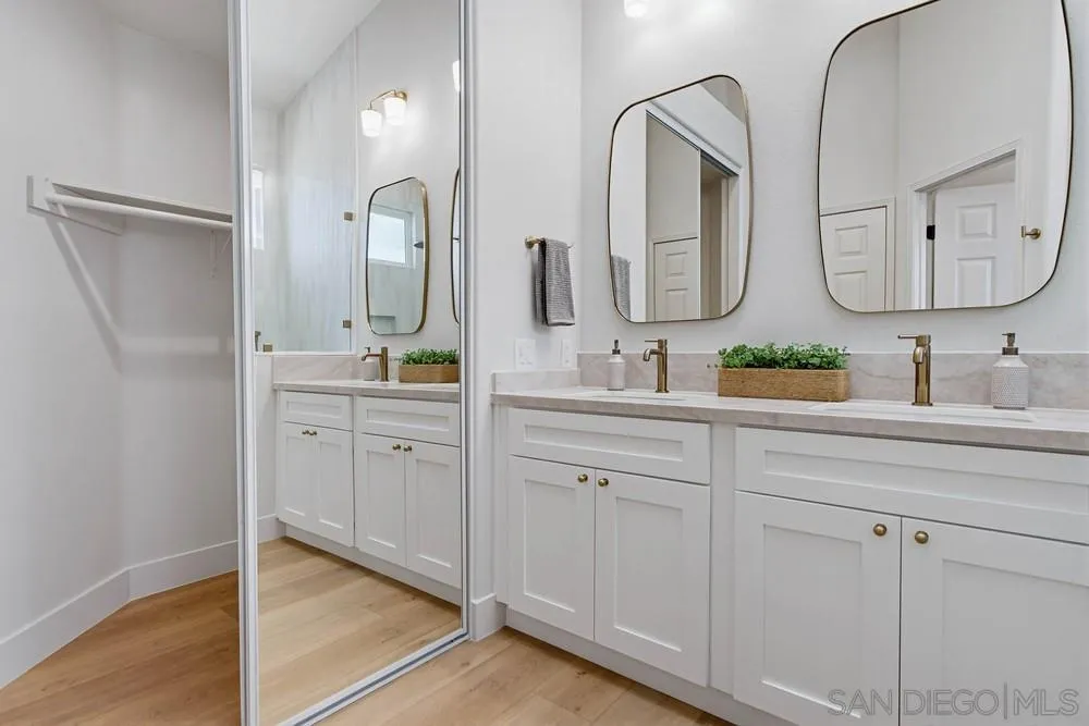 4959 Lamia Way Oceanside, CA 92056 - Photo 42 of 63 a en suite bathroom with double vanity sinks and a mirror