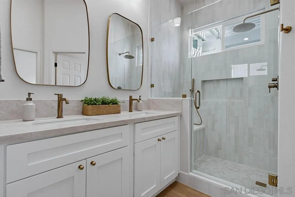 4959 Lamia Way Oceanside, CA 92056 - Photo 43 of 63 a bathroom with a double vanity sink mirror and shower