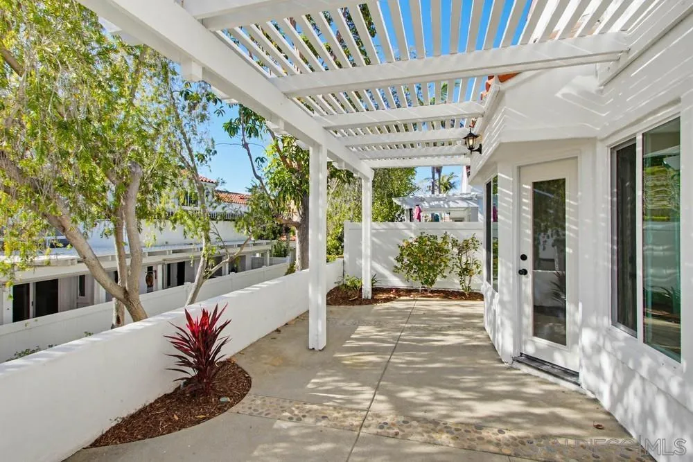 4959 Lamia Way Oceanside, CA 92056 - Photo 56 of 63 a porch with a table and chairs