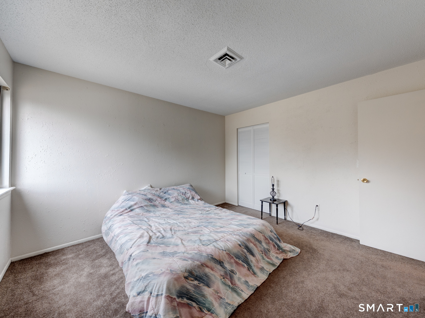 285 Queen Street, Unit 1C Southington, CT 06489 - Photo 21 of 33 a bedroom with a bed and a table