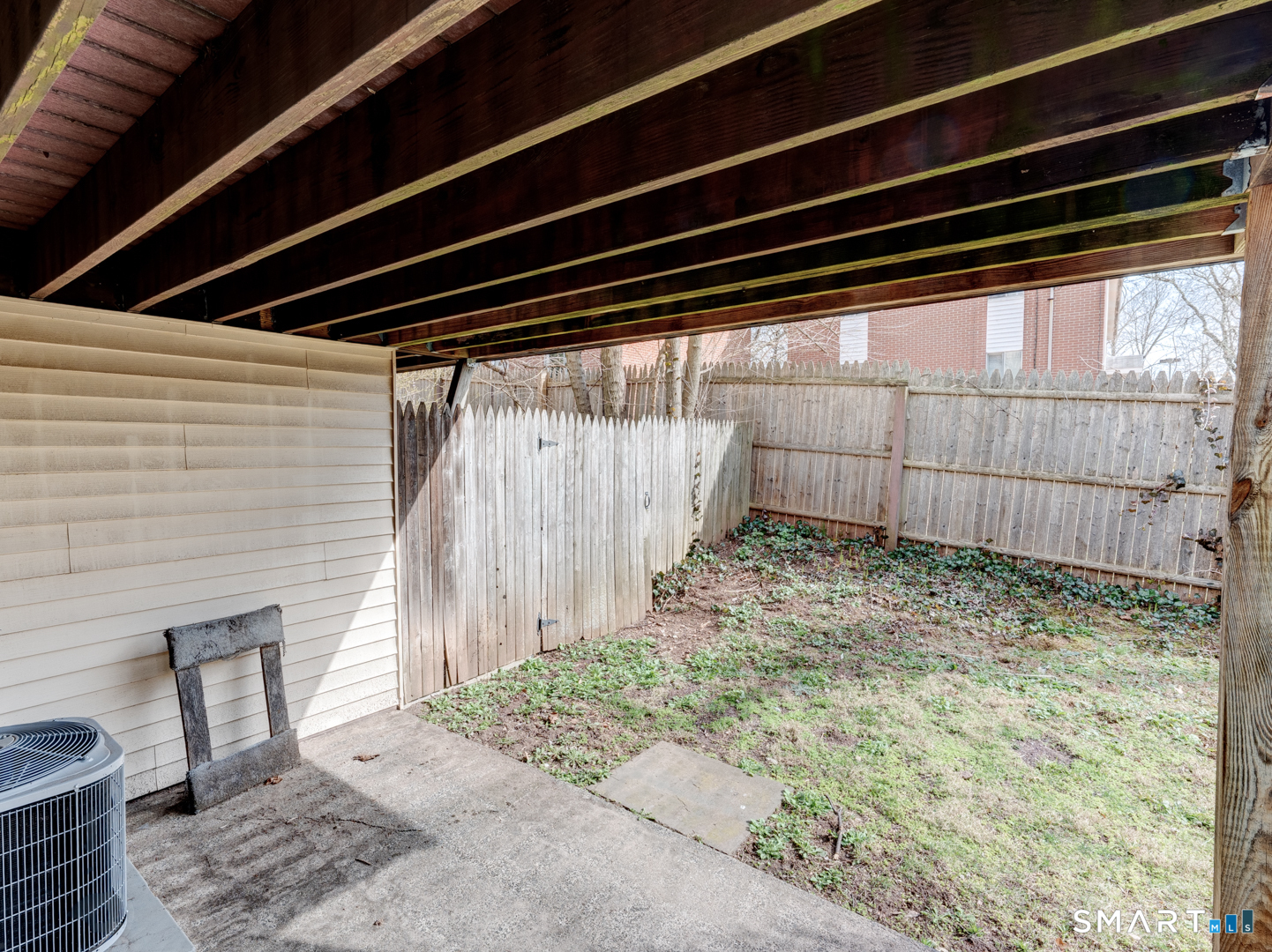 285 Queen Street, Unit 1C Southington, CT 06489 - Photo 24 of 33 a backyard of a house with a small barn and wooden floor
