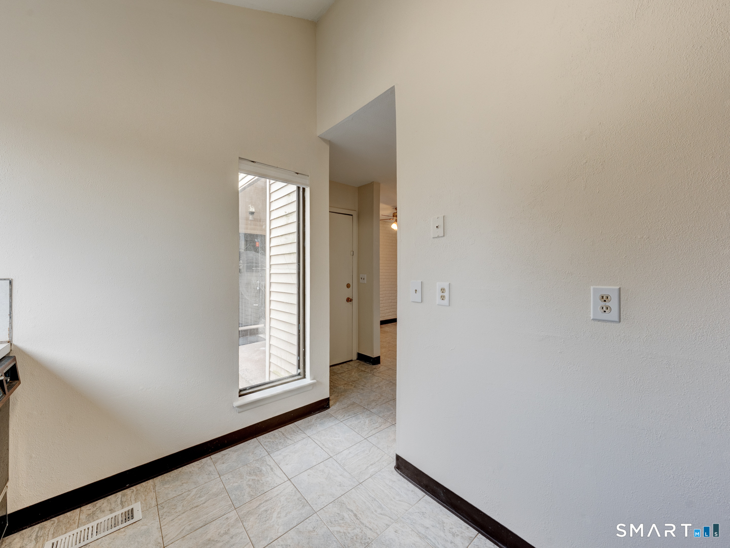 285 Queen Street, Unit 1C Southington, CT 06489 - Photo 5 of 33 a view of an empty room with a window