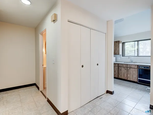 a view of a kitchen with a refrigerator and a sink