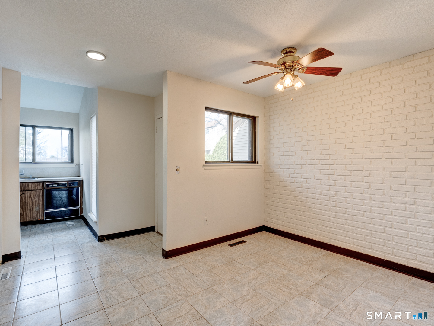 285 Queen Street, Unit 1C Southington, CT 06489 - Photo 7 of 33 en empty room with windows and ceiling fan