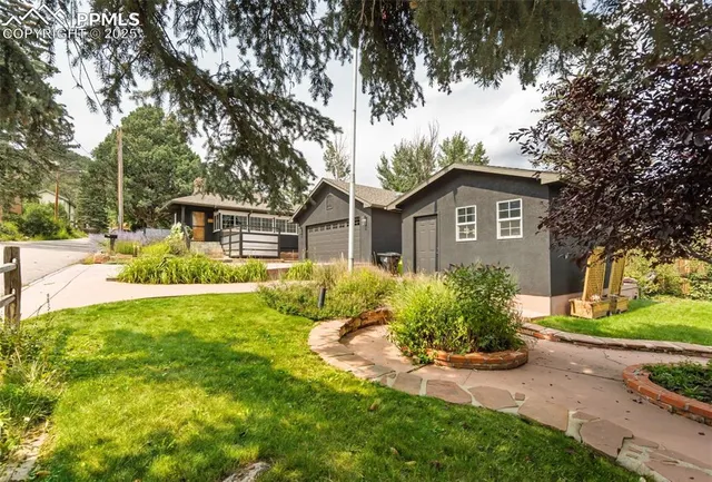 a front view of a house with a yard and trees