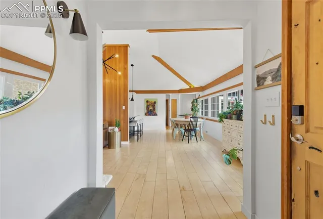 a living room with furniture a fireplace and a large window