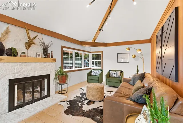 a dining room with furniture and a floor to ceiling window