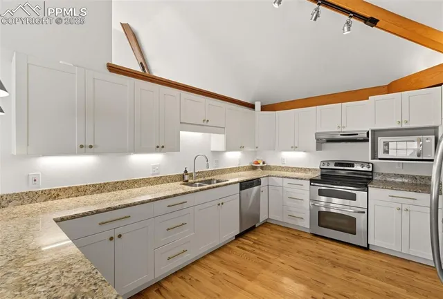 a kitchen with a sink and cabinets