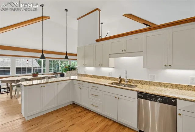 a kitchen with a sink a refrigerator and cabinets