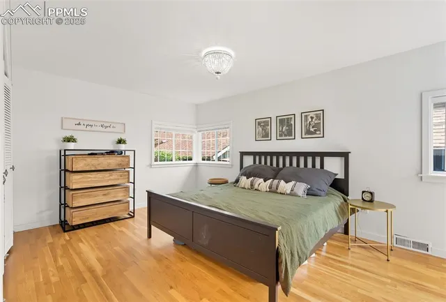 a bedroom with a large bed and a window