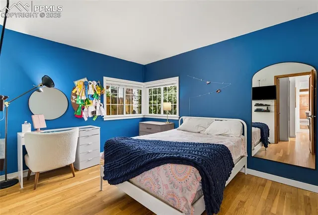 a bedroom with furniture and wooden floor
