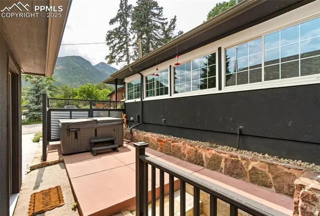 a view of house with backyard and a tree