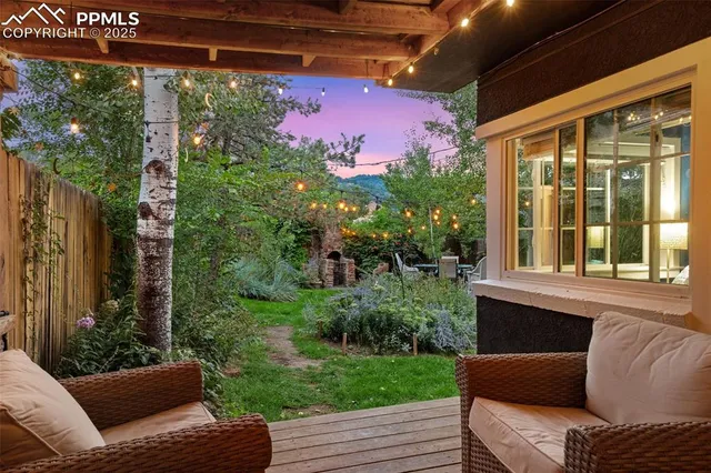 a view of a patio with table and chairs and potted plants