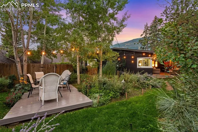 a view of a patio with table and chairs and potted plants