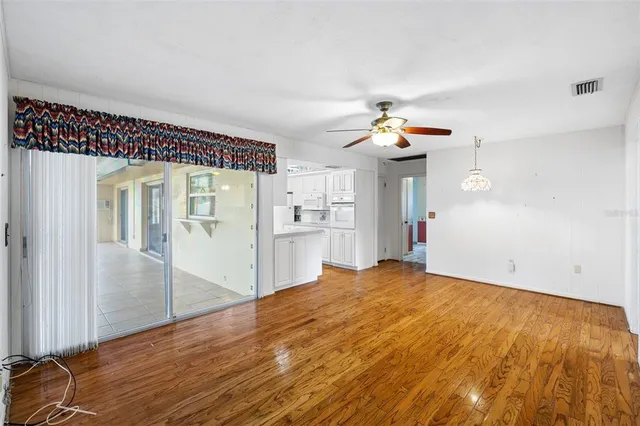 a view of a kitchen with wooden floor and a window