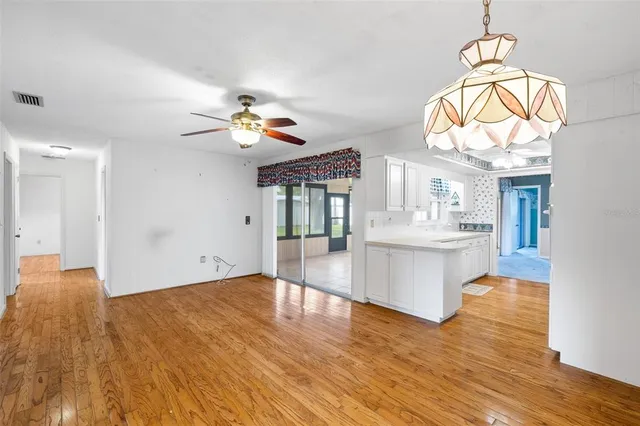 a view of living room with wooden floor and white walls