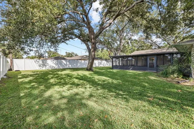 a view of house with a yard