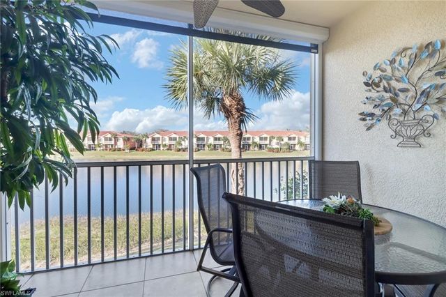a view of a chairs and table in a balcony