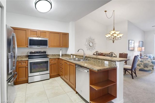 a kitchen with a stove cabinets and dining table