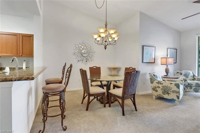 a dining room with furniture and chandelier
