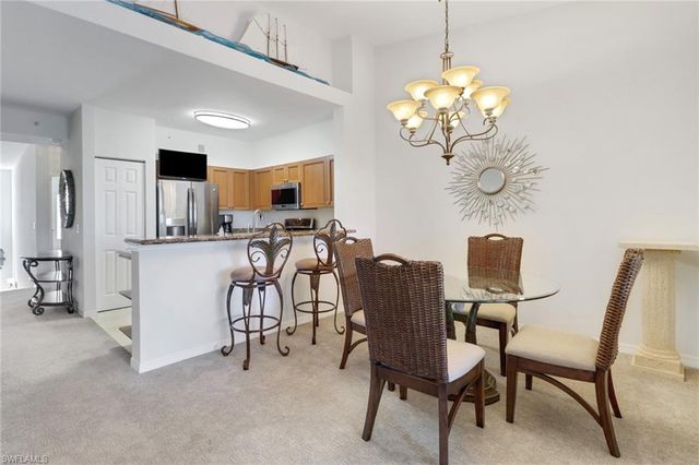 a view of a dining room with furniture and a chandelier