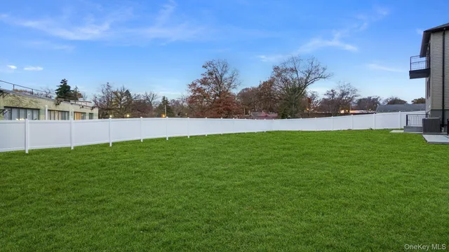 a view of yard with swimming pool and trees in the background