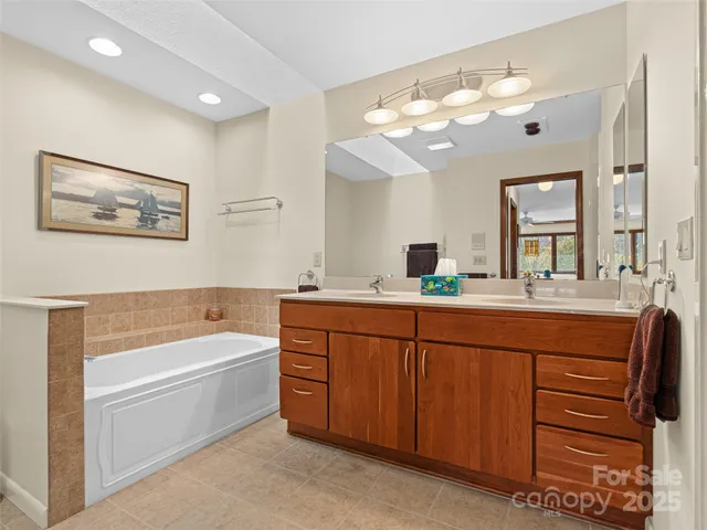 a spacious bathroom with a shower sink mirror and