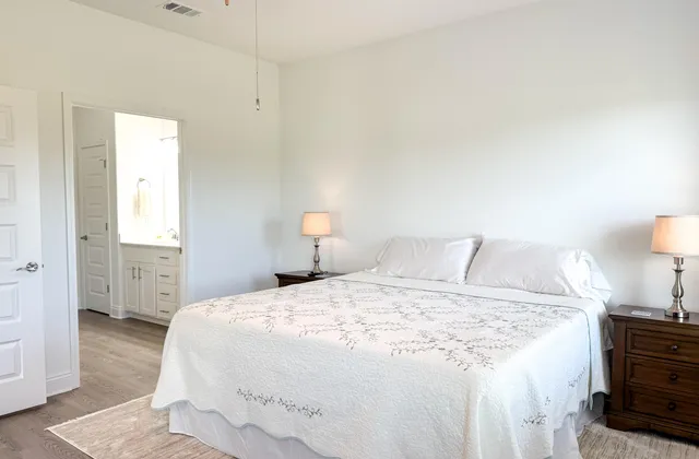 a bedroom with a bed and a lamp