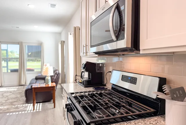 a kitchen with a stove and a microwave