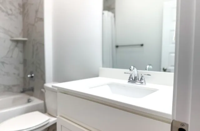 a bathroom with a sink toilet and tub