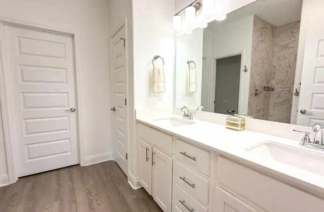 a bathroom with a double vanity sink and a mirror