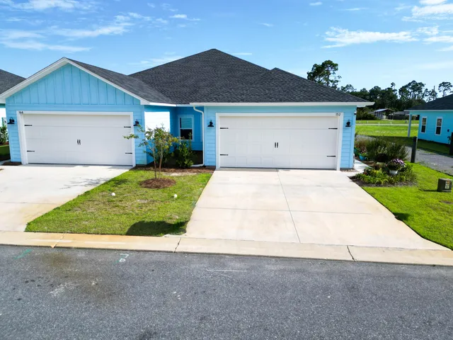 an aerial view of houses with yard