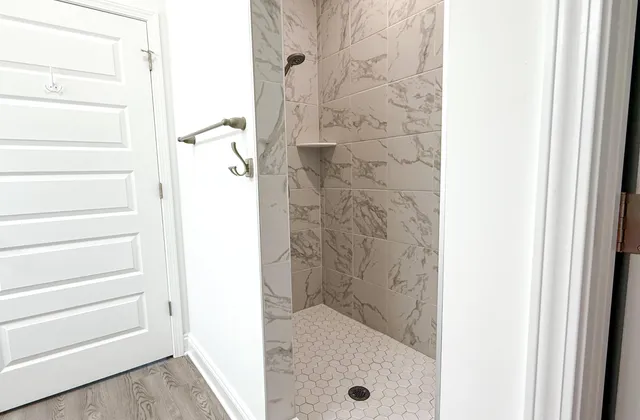 a bathroom with a glass shower door