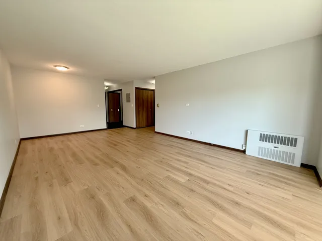 a view of a room with wooden floor