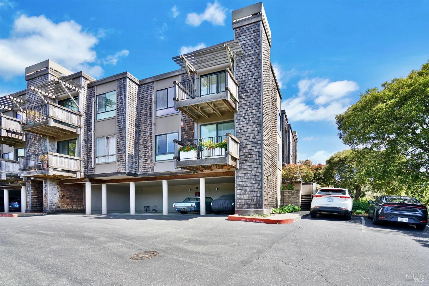 a couple of cars parked in front of a building