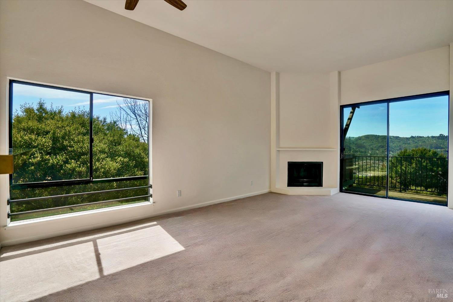 600 Seaver Drive Mill Valley, CA 94941 - Photo 14 of 30 a view of an empty room with a fireplace and a window