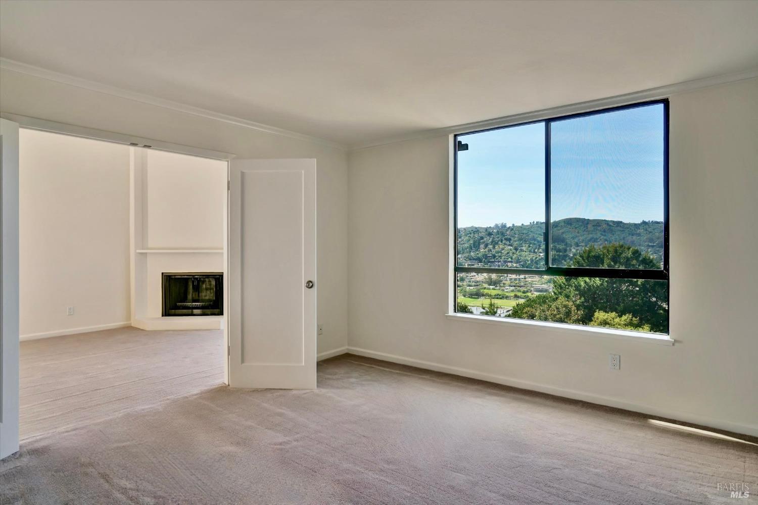 600 Seaver Drive Mill Valley, CA 94941 - Photo 23 of 30 an empty room with windows and a fireplace