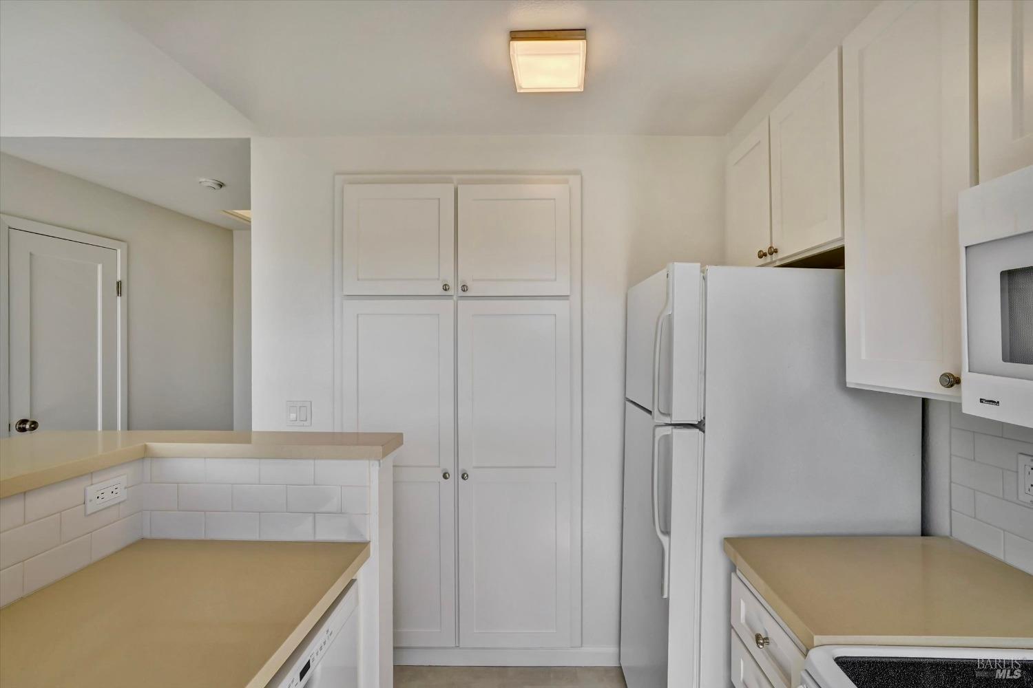 600 Seaver Drive Mill Valley, CA 94941 - Photo 9 of 30 a kitchen with a refrigerator and cabinets