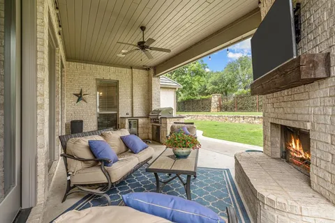 a outdoor living space with furniture and a fireplace