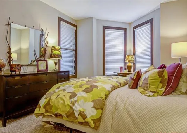 a bedroom with two beds and a mirror