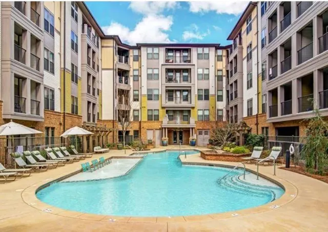 a view of tall building with swimming pool and sitting space