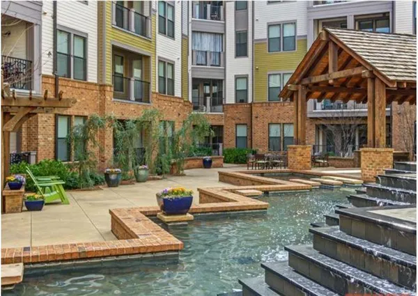 a view of a building with swimming pool and sitting area