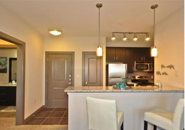 a view of a kitchen with a table and chairs